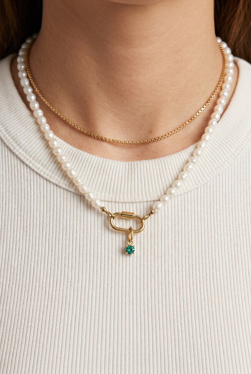 Model wearing the freshwater pearl necklace with gold carabiner clasp and a small birthstone charm